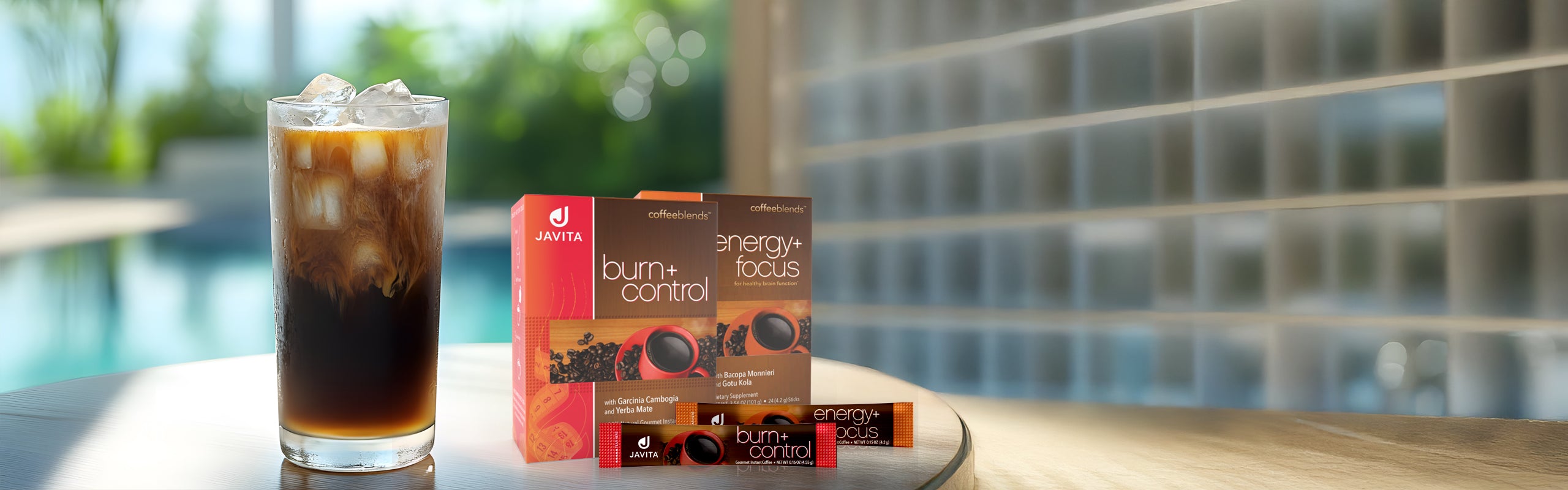 Glass of Ice Coffee with a box of burn + control coffee and energy + focus coffee.