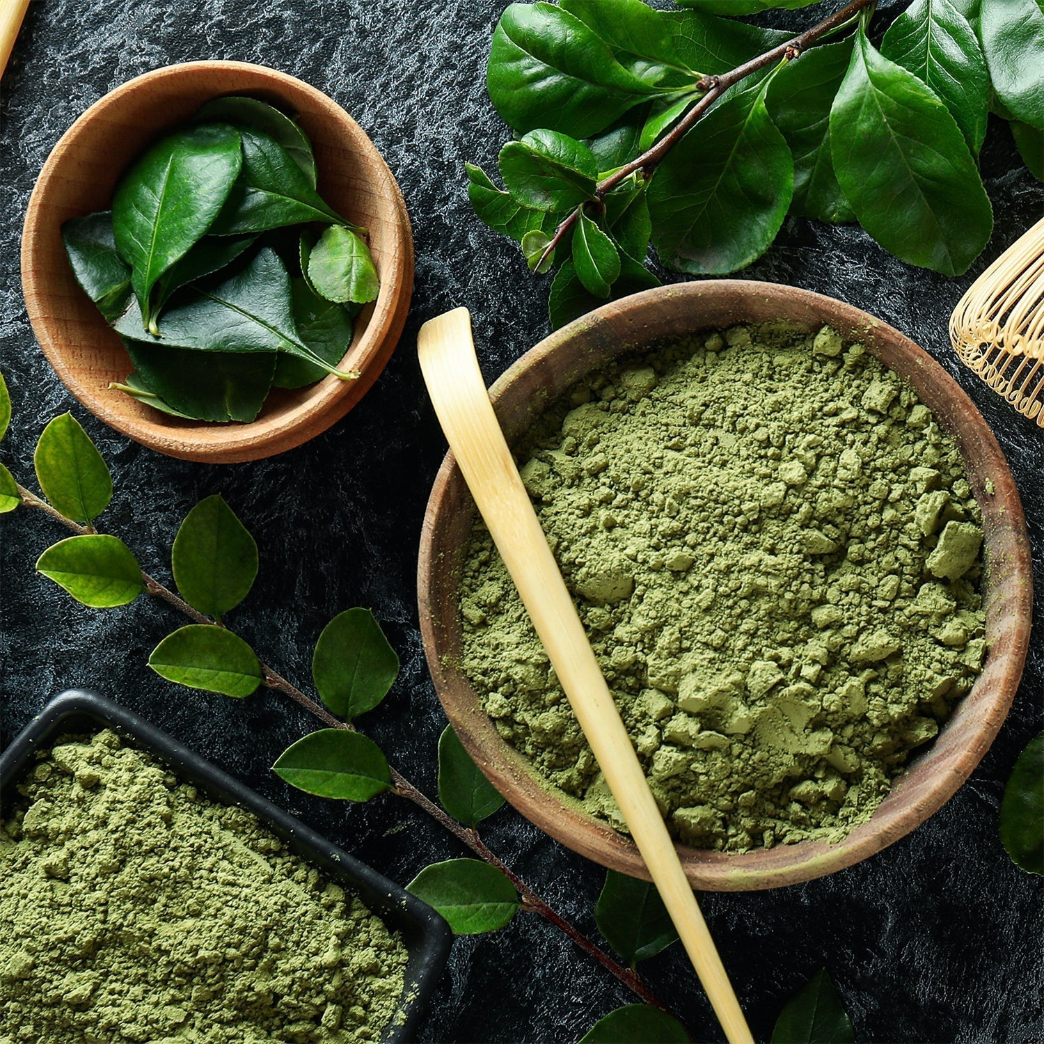 Green Tea powder in woddent bowl, green tea leafs in wodden bowl